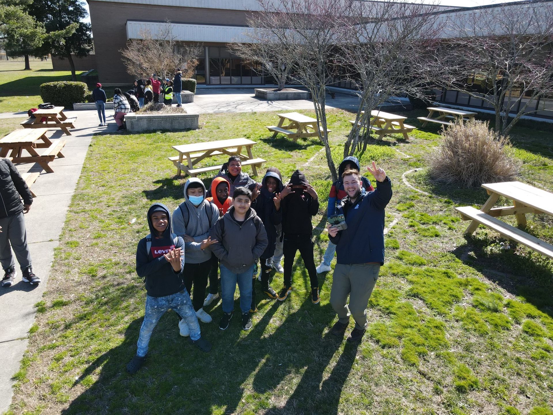 Image of RETEX's Josh Lewis teaching local 7th graders how to fly a drone.
