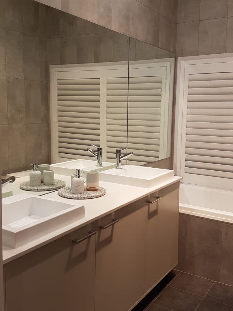 A Bathroom with Two Sinks and A Large Mirror — Winning Blinds in Cardiff, NSW