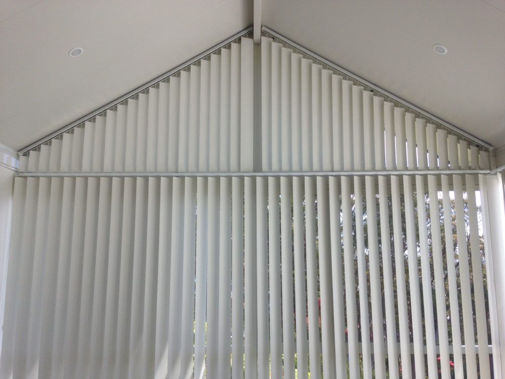 A Room with A Vaulted Ceiling and Vertical Blinds on The Windows — Winning Blinds in Cardiff, NSW