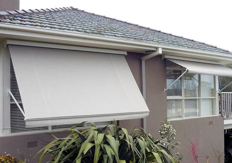 A Window with A Striped Awning on It — Winning Blinds in Cardiff, NSW