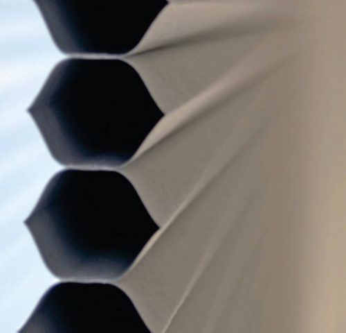 A close up of a honeycomb blind on a window — Winning Blinds in Cardiff, NSW