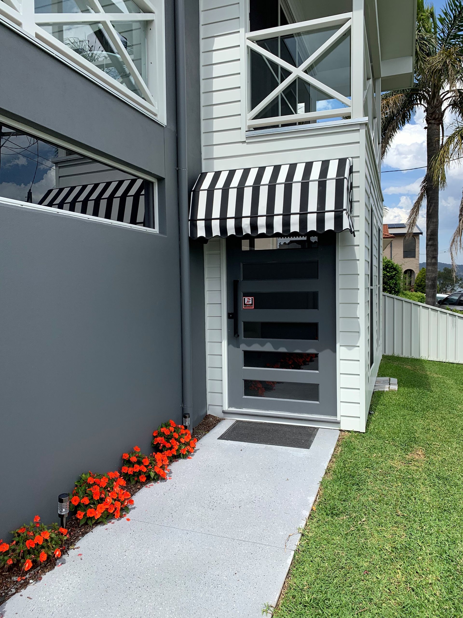 A House With a Black Awning on the Side of It — Winning Blinds in Cardiff, NSW