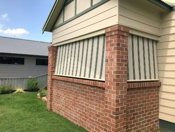 Brick-walled Porch With Beige Window Coverings — Winning Blinds in Cardiff, NSW