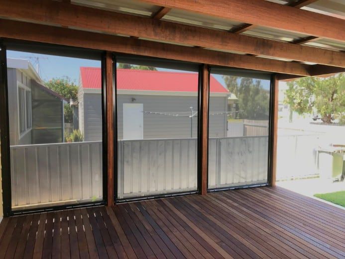 Wooden Deck With Three Roller Screens — Winning Blinds in Cardiff, NSW