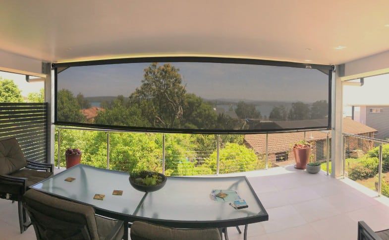 Patio With A Large, Black Outdoor Shade — Winning Blinds in Cardiff, NSW