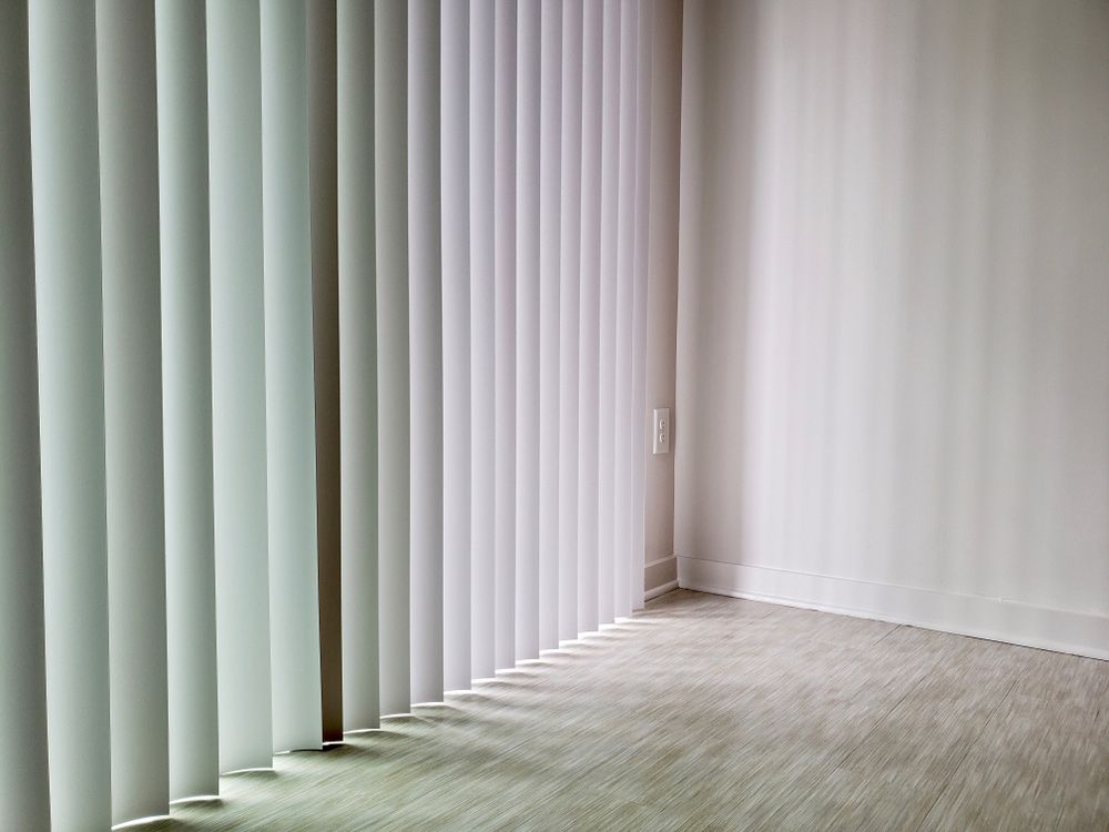 White Vertical Blinds in An Empty Room