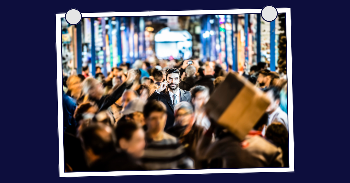 Blue figure stands out in a circle of woode figures, symbolising recruiters in a crowded market.