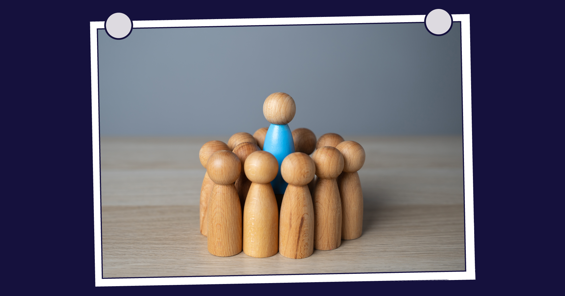 Blue figure stands out in a circle of wooden figures, symbolising recruiters in a crowded market.