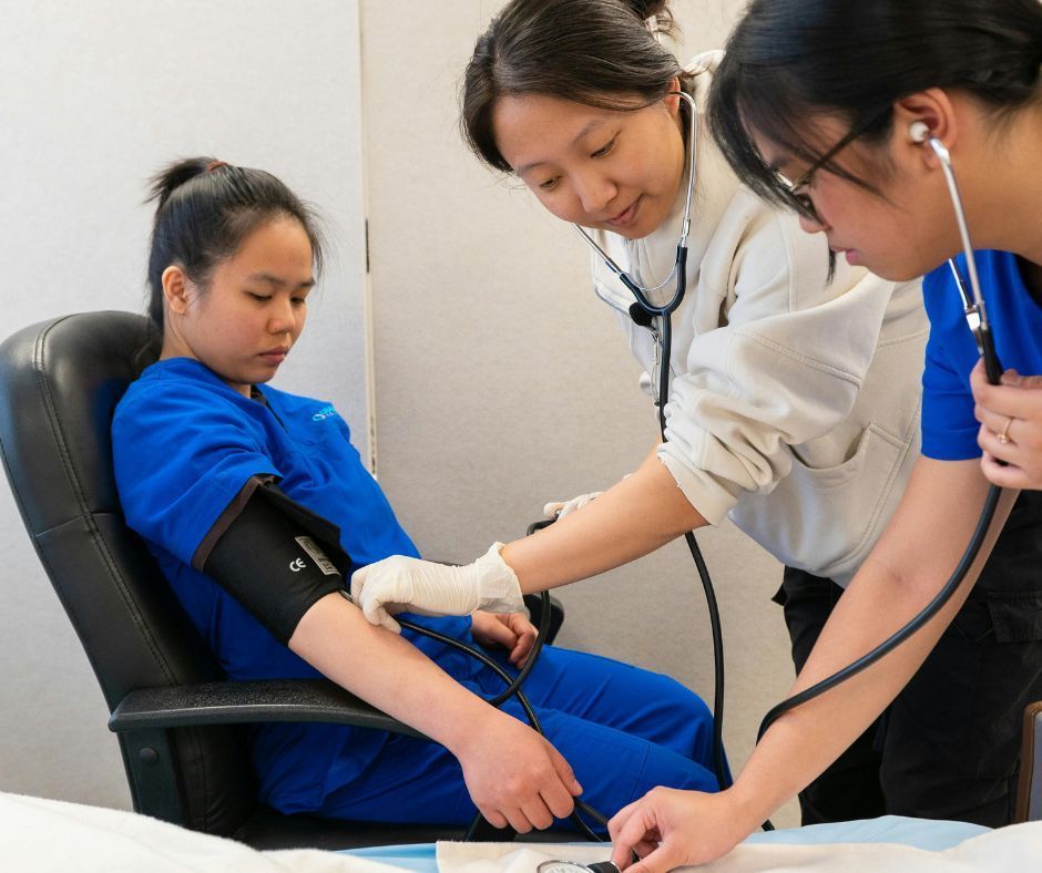 Blood pressure test performed by healthcare staff at a medical centre.