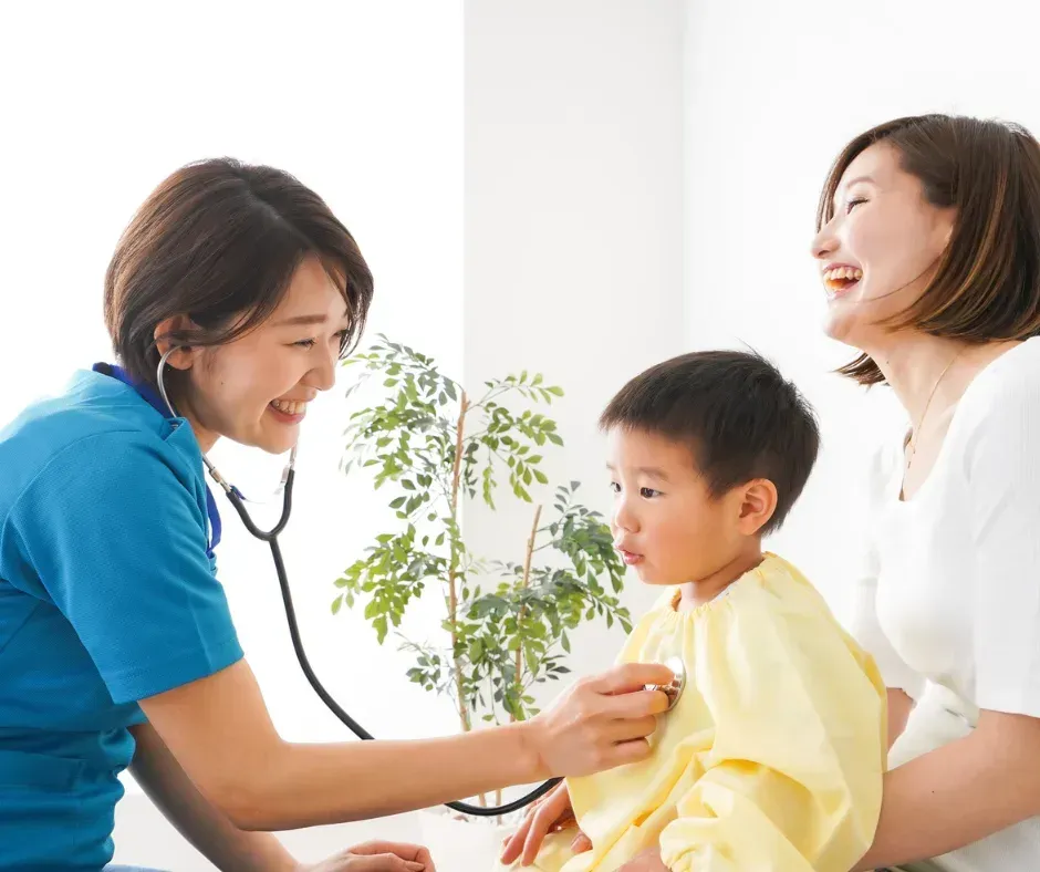 Doctor checking child with stethoscope.