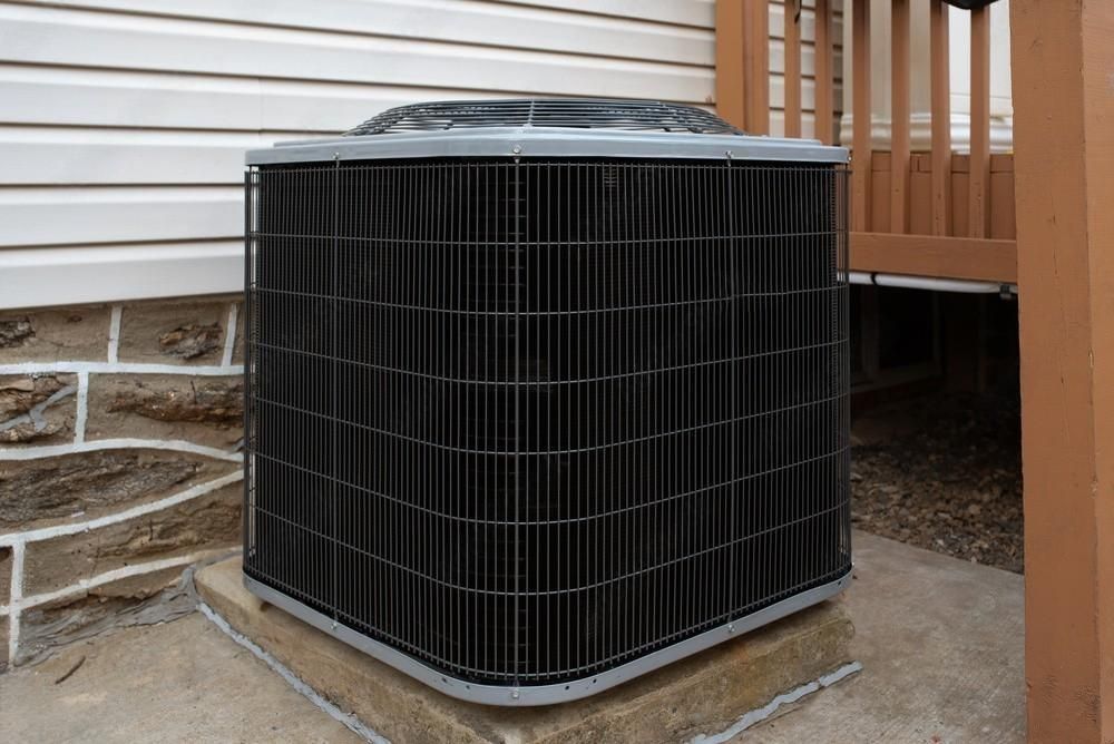 an air conditioner is sitting on the side of a house .
