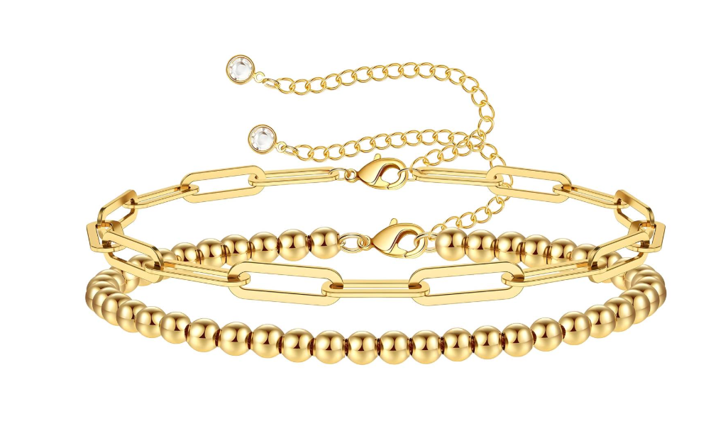 Gouden armbandenset: schakelketting, kralenketting, verstelbaar verlengstuk met kleine kristallen.