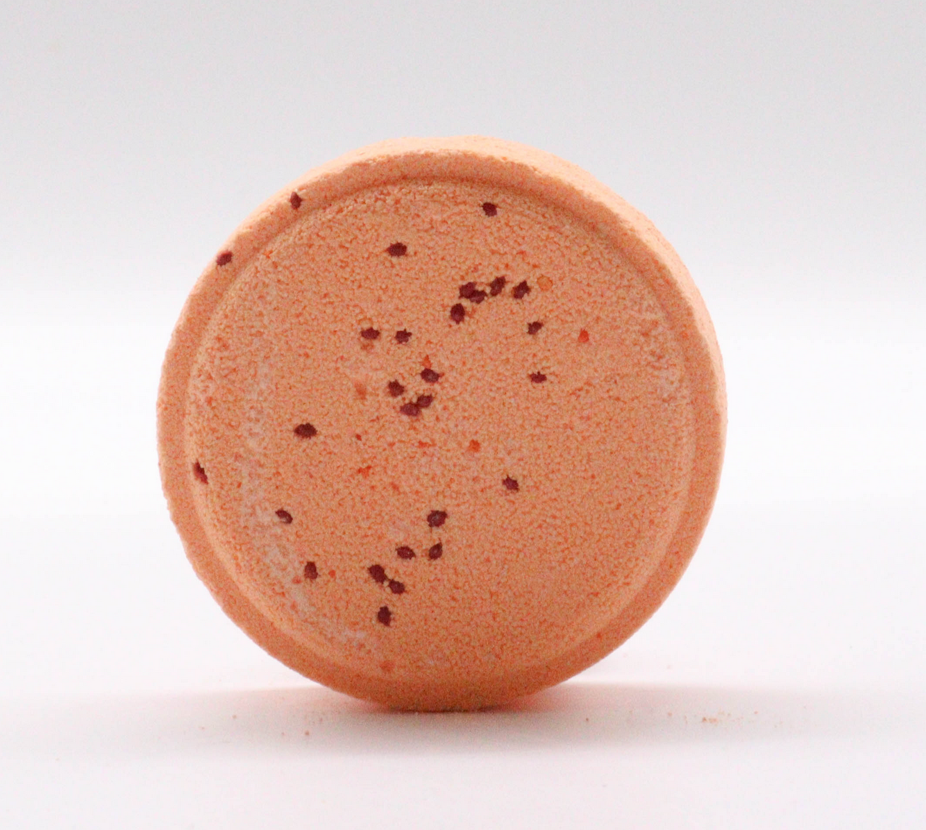 Sinaasappelbadbom met cranberry's, sinaasappelschijfjes en munt.