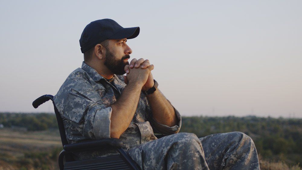 Wheelchaired Soldier Looking Away Into Distance — Summerville, SC — Shepherd Law Firm, LLC