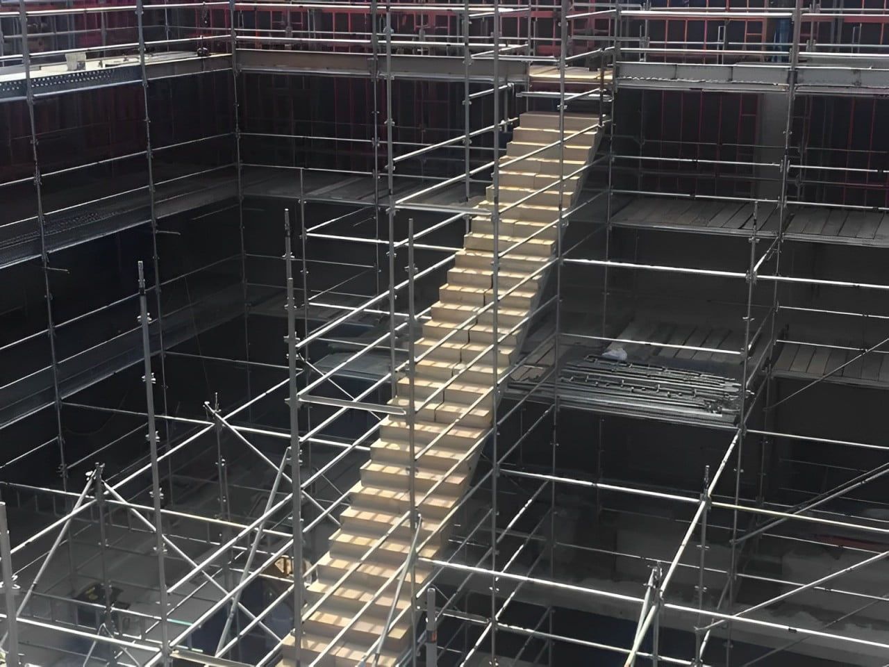 A Building Under Construction With Scaffolding And Stairs — Fahlstrom Scaffolding Cairns Pty Ltd in Gordonvale, QLD