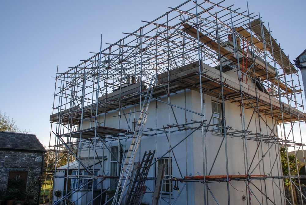 A House Is Being Built With Scaffolding Around It — Fahlstrom Scaffolding Cairns Pty Ltd in Gordonvale, QLD