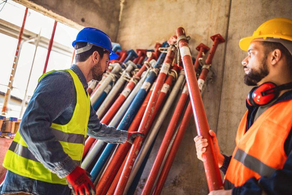 Two Construction With A Pile Of Scaffolding  — Fahlstrom Scaffolding Cairns Pty Ltd in Tablelands, QLD