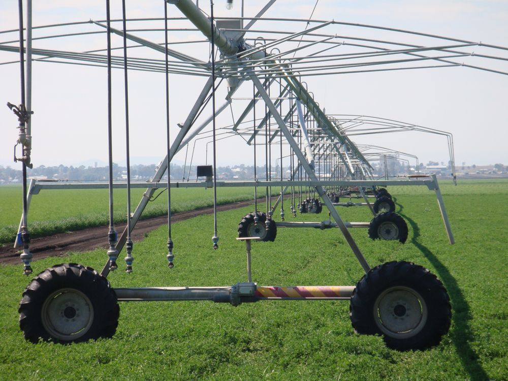 A Row of Irrigation Equipment in a Grassy Field — Stockers & Partridge In Maitland, NSW