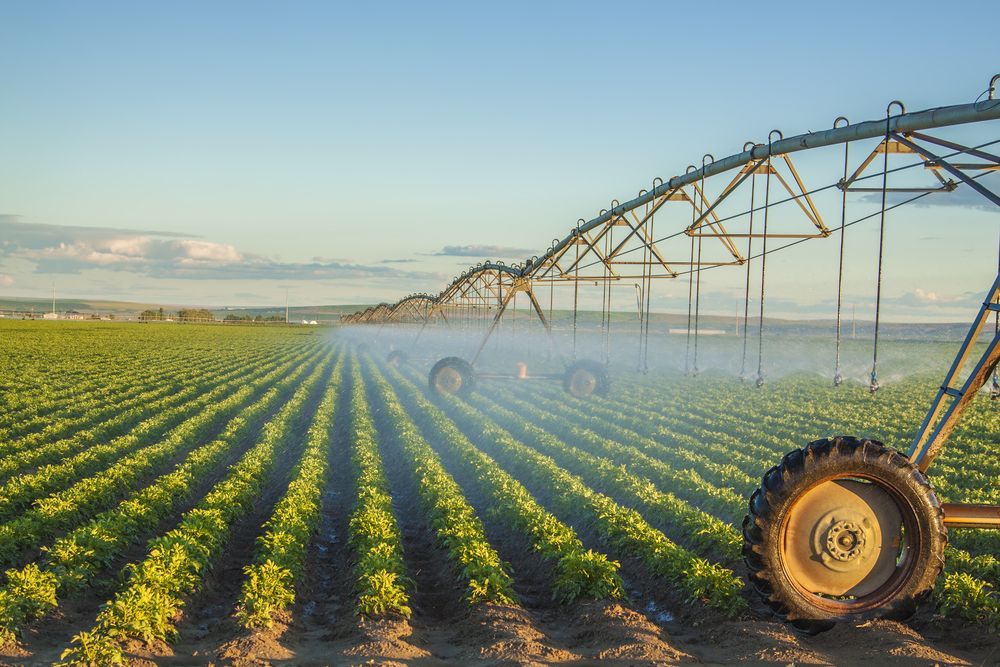 A Tractor is Watering a Field of Plants With a Irrigation System— Stockers & Partridge In Maitland, NSW