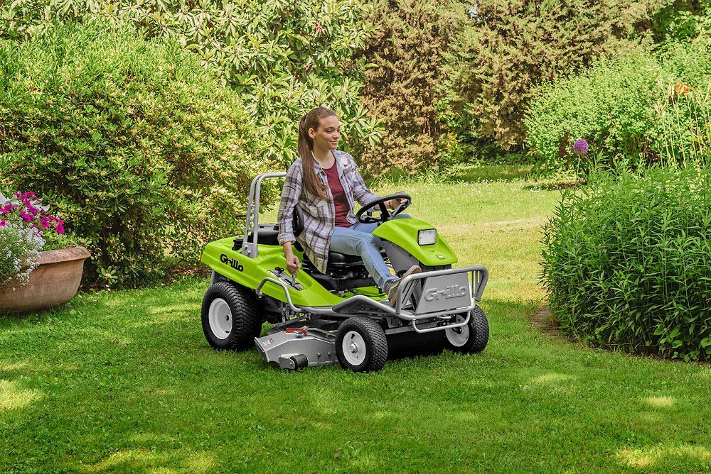 A Person is Riding a Lawn Mower on a Lush Green Field — Stockers & Partridge In Pokolbin, NSW