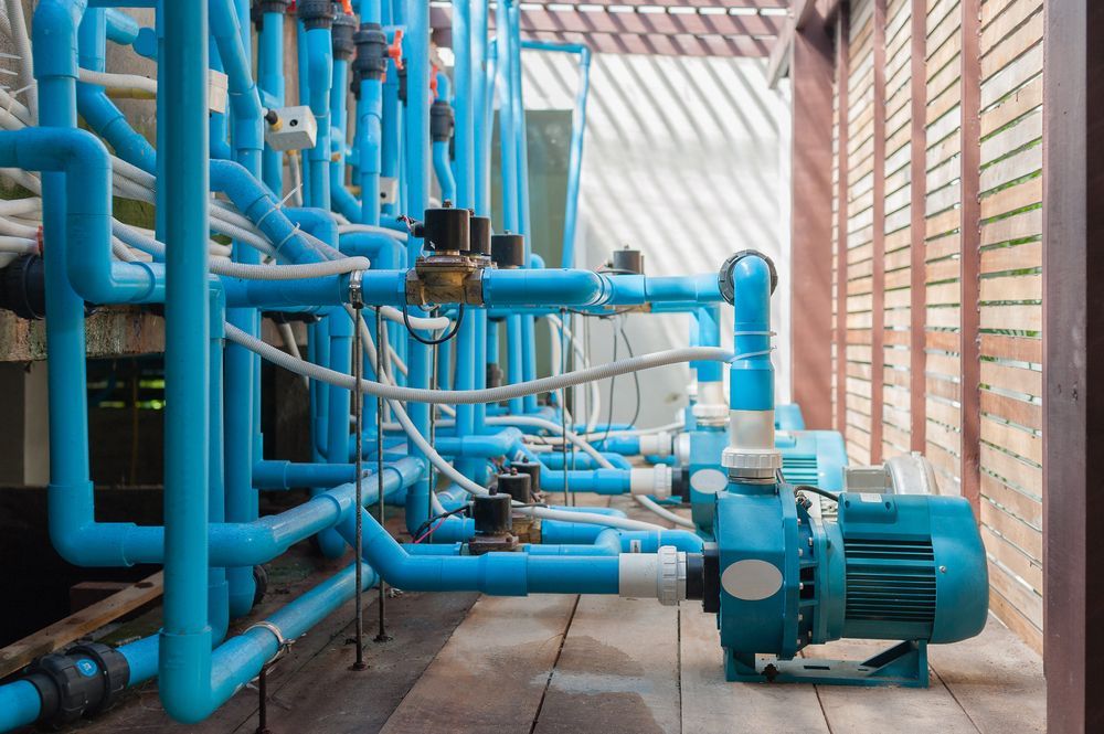 A Room Filled With Lots of Blue Pipes and a Pump — Stockers & Partridge In Dungog, NSW