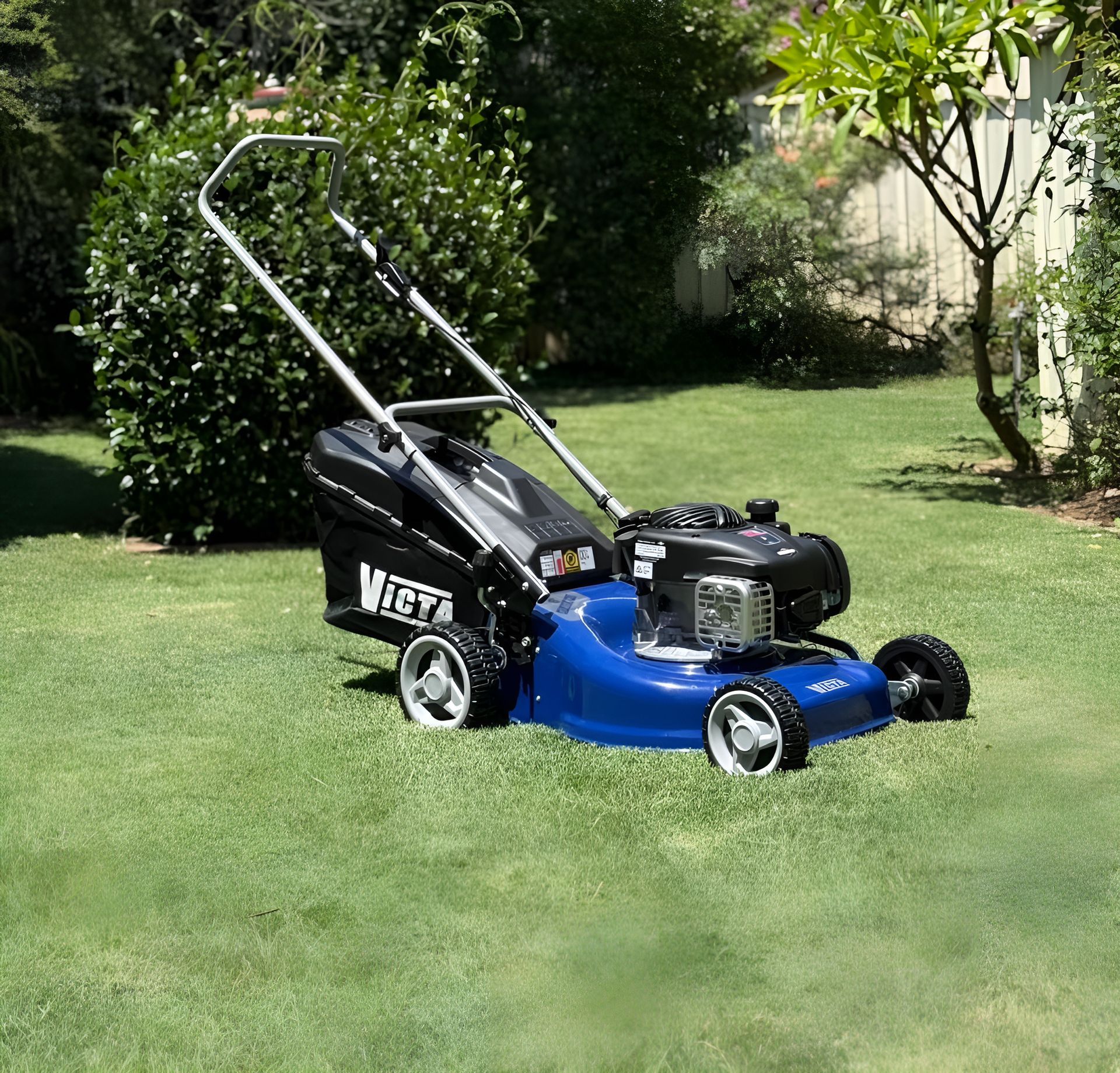 A Blue Lawn Mower is Parked on a Lush Green Lawn — Stockers & Partridge In Paterson, NSW