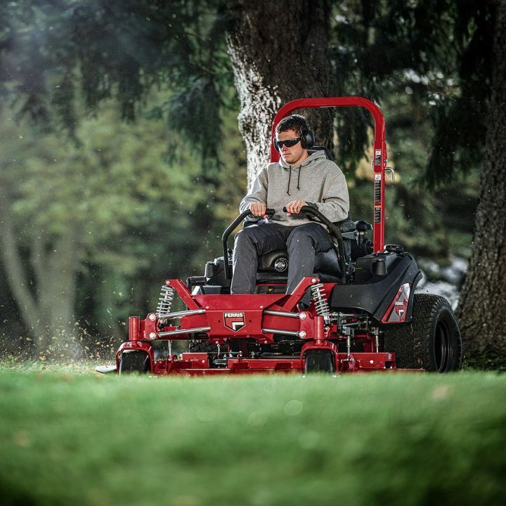 A Man is Riding a Red Lawn Mower in a Park — Stockers & Partridge In Paterson, NSW