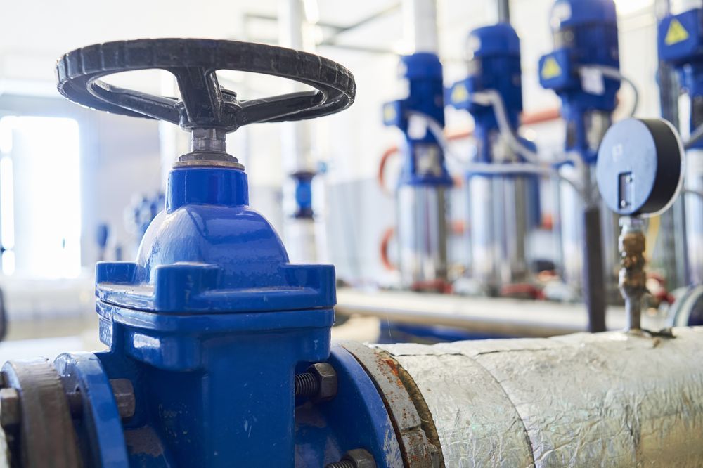 A Close Up of a Blue Valve on a Pipe in a Factory — Stockers & Partridge In Maitland, NSW