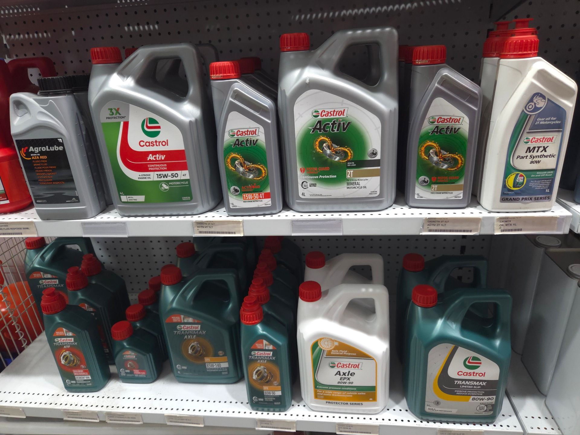 A Shelf Filled With Bottles of Oil Including Castrol — Stockers & Partridge In Paterson, NSW