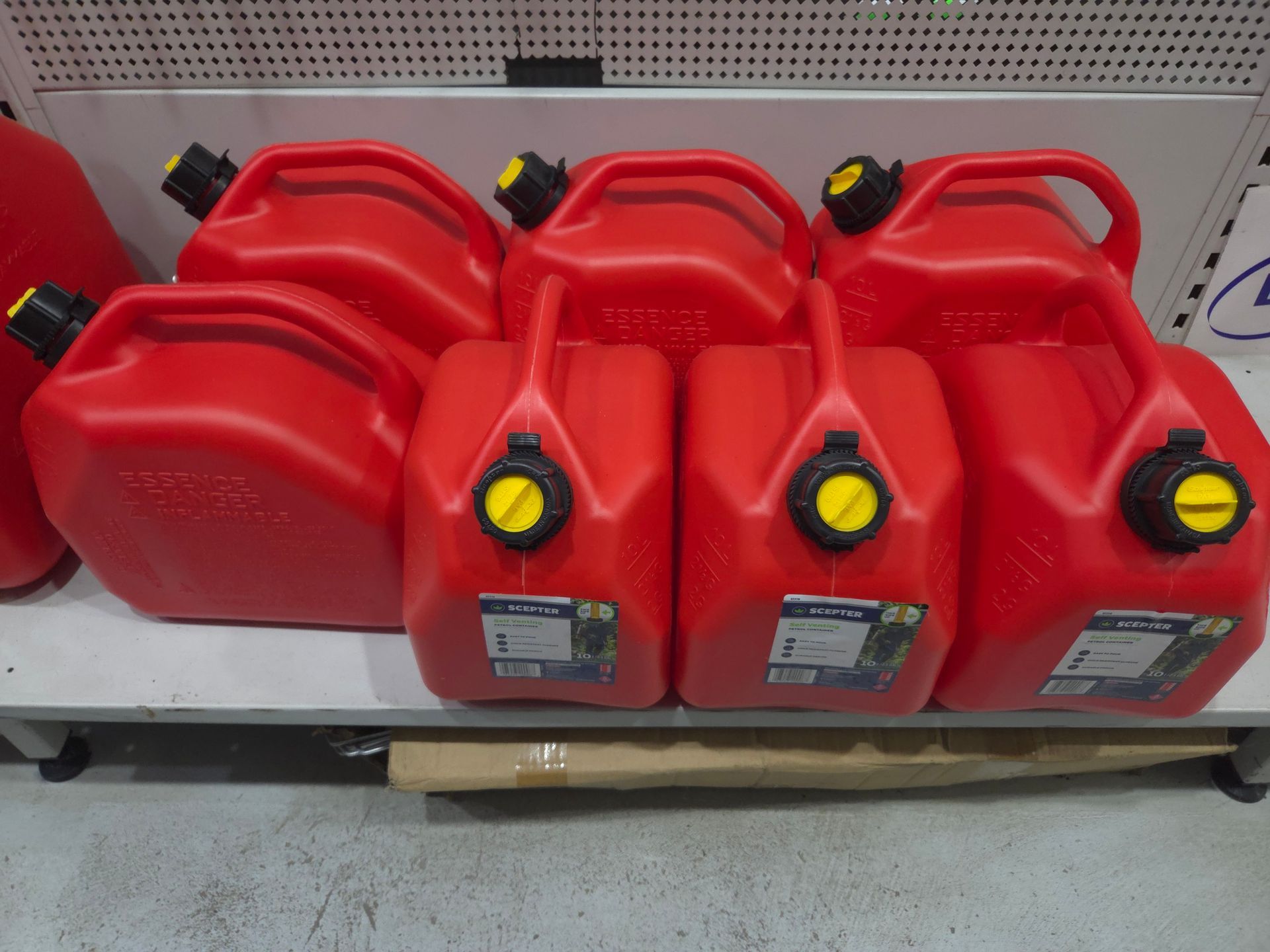 Several Red Gas Cans Are Lined Up on a Shelf — Stockers & Partridge In Paterson, NSW
