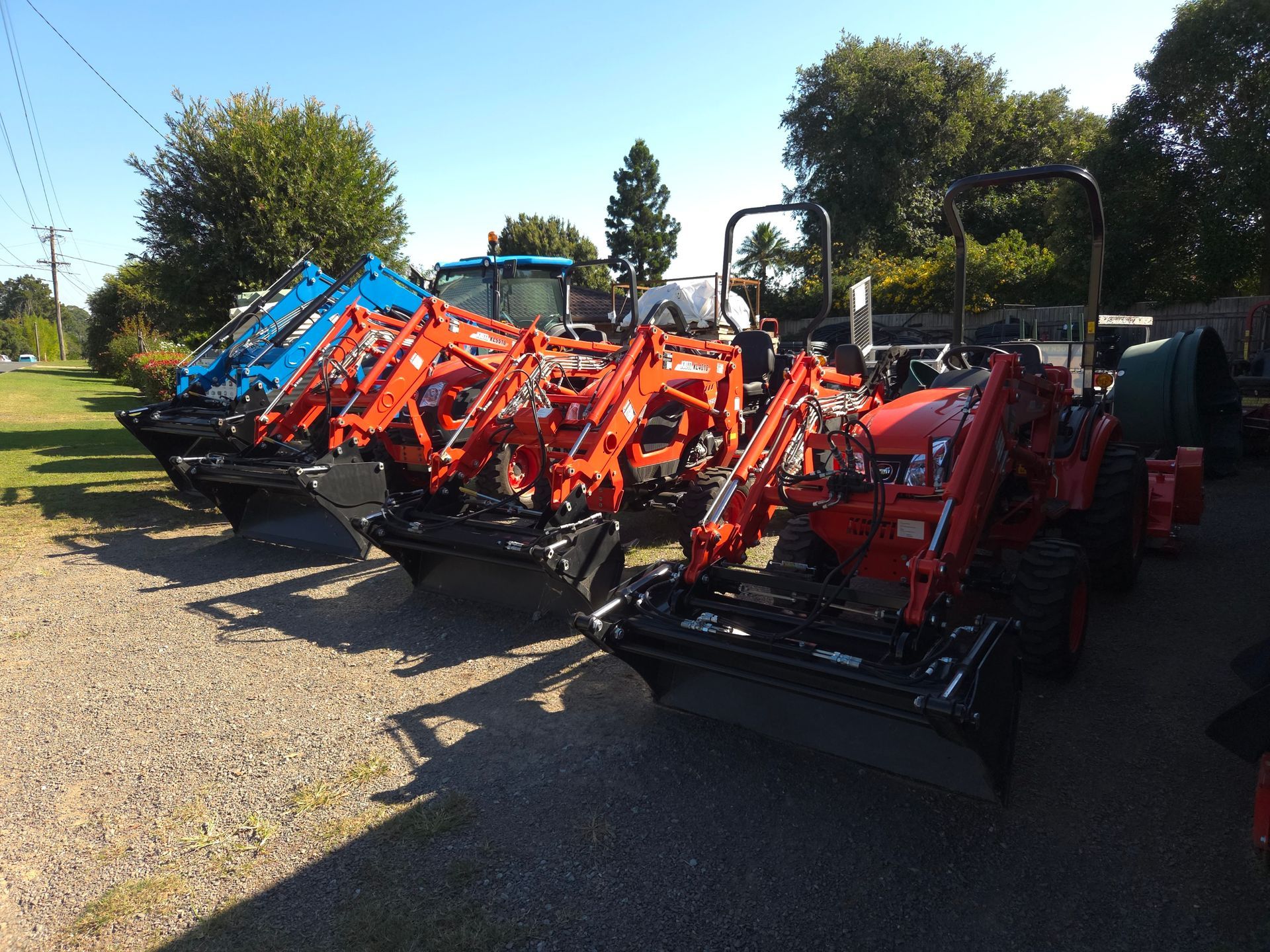 A Tractor With a Trailer is Driving Through a Wheat Field — Stockers & Partridge In Raymond Terrace, NSW