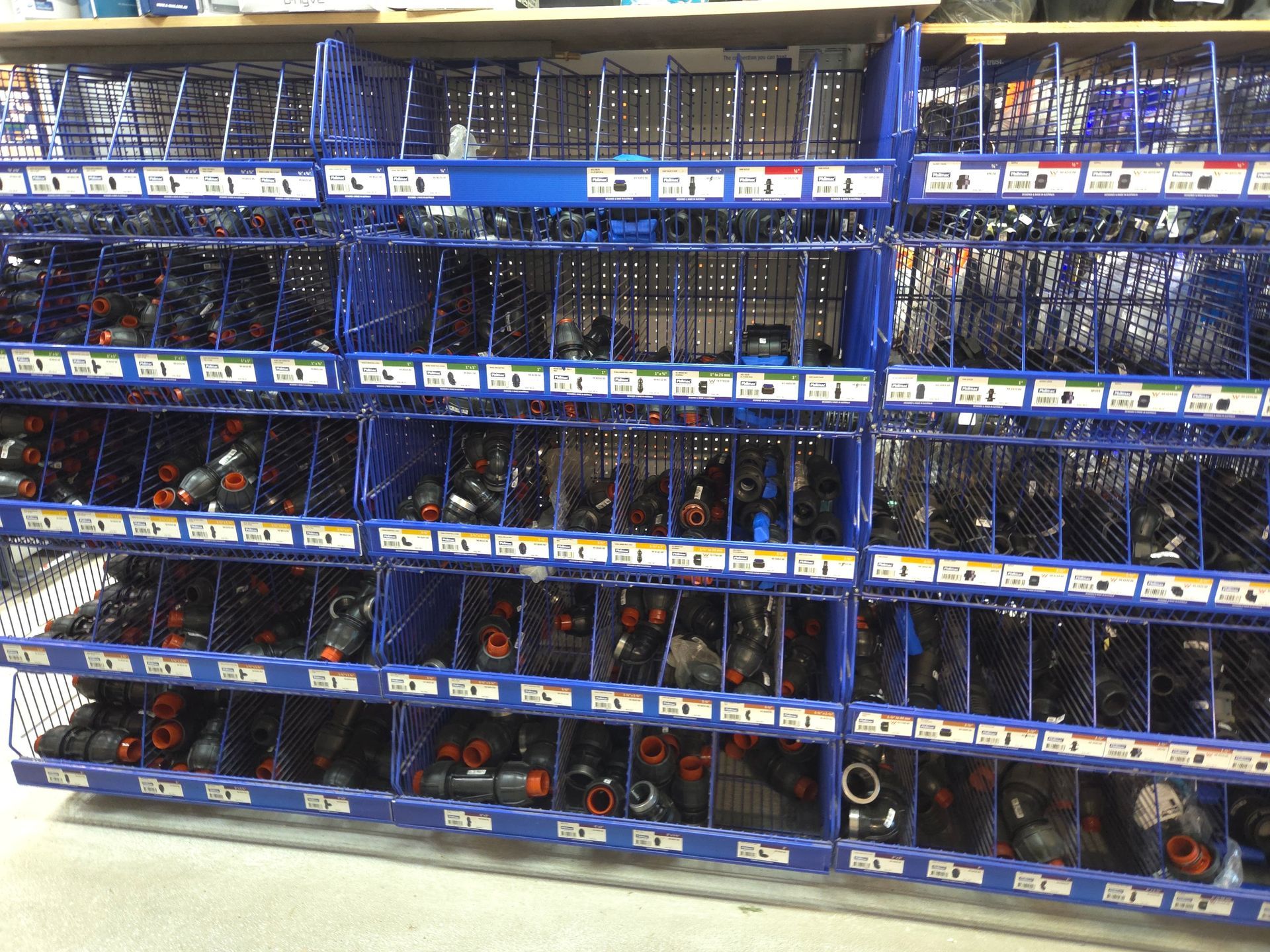 A Store Shelf Filled With Lots of Blue Bins — Stockers & Partridge In Paterson, NSW