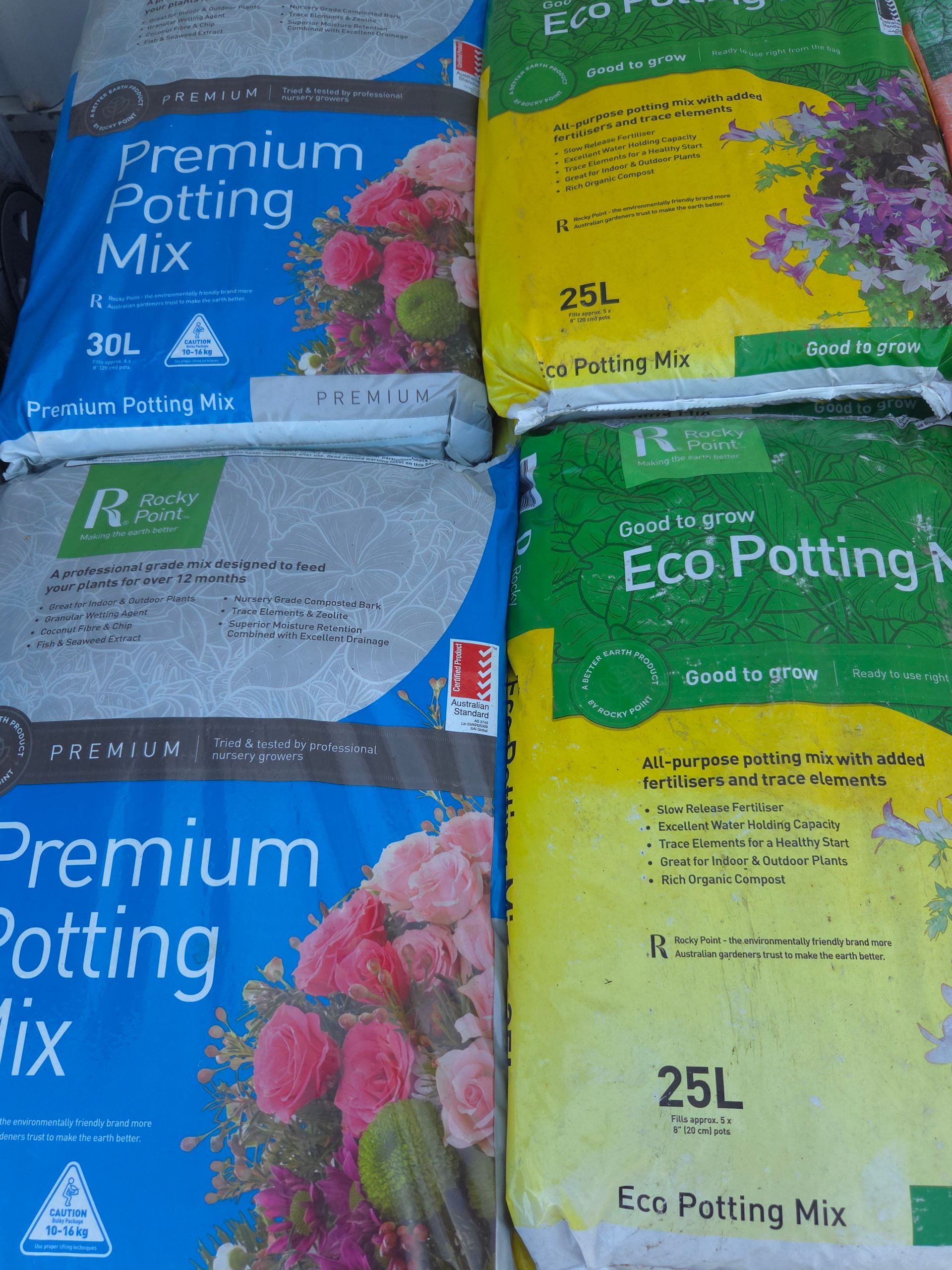 Several Bags of Premium Potting Mix Are Stacked on Top of Each Other — Stockers & Partridge In Paterson, NSW