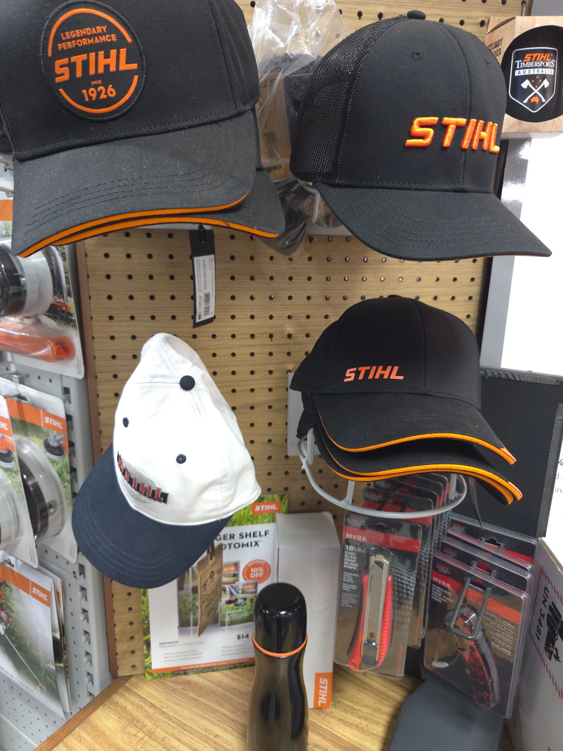 A Display of Stihl Hats and a Bottle of Water — Stockers & Partridge In Paterson, NSW