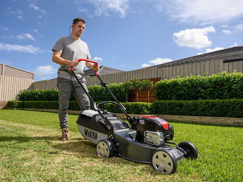 A Blue Lawn Mower is Parked on a Lush Green Lawn — Stockers & Partridge In Paterson, NSW