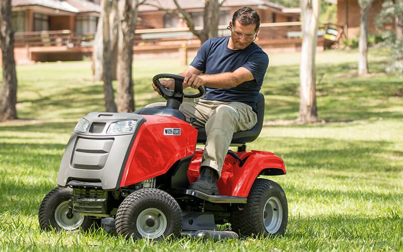 A Red Lawn Mower With a Shock Absorber Attached to It — Stockers & Partridge In Pokolbin, NSW