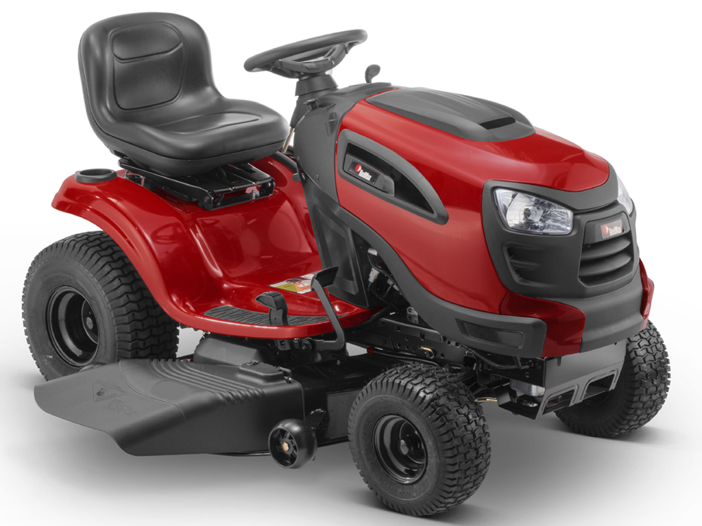 Three Red Lawn Mowers Are Parked in a Grassy Field Next to a Puddle of Water — Stockers & Partridge In Maitland, NSW