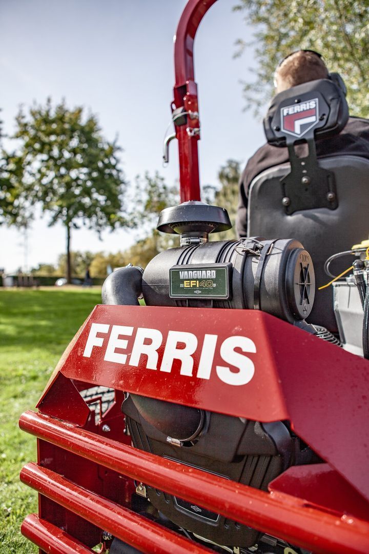 A Man is Sitting on a Ferris Lawn Mower in a Park — Stockers & Partridge In Paterson, NSW