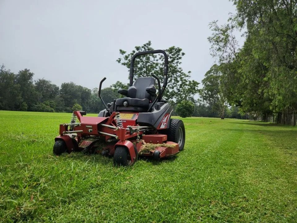 Person on a Green Riding Lawnmower Cutting Grass — Stockers & Partridge In Pokolbin, NSW