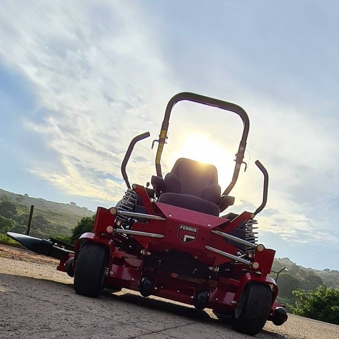 A Red Toro Zero Turn Lawn Mower is Parked on the Side of the Road — Stockers & Partridge In Paterson, NSW