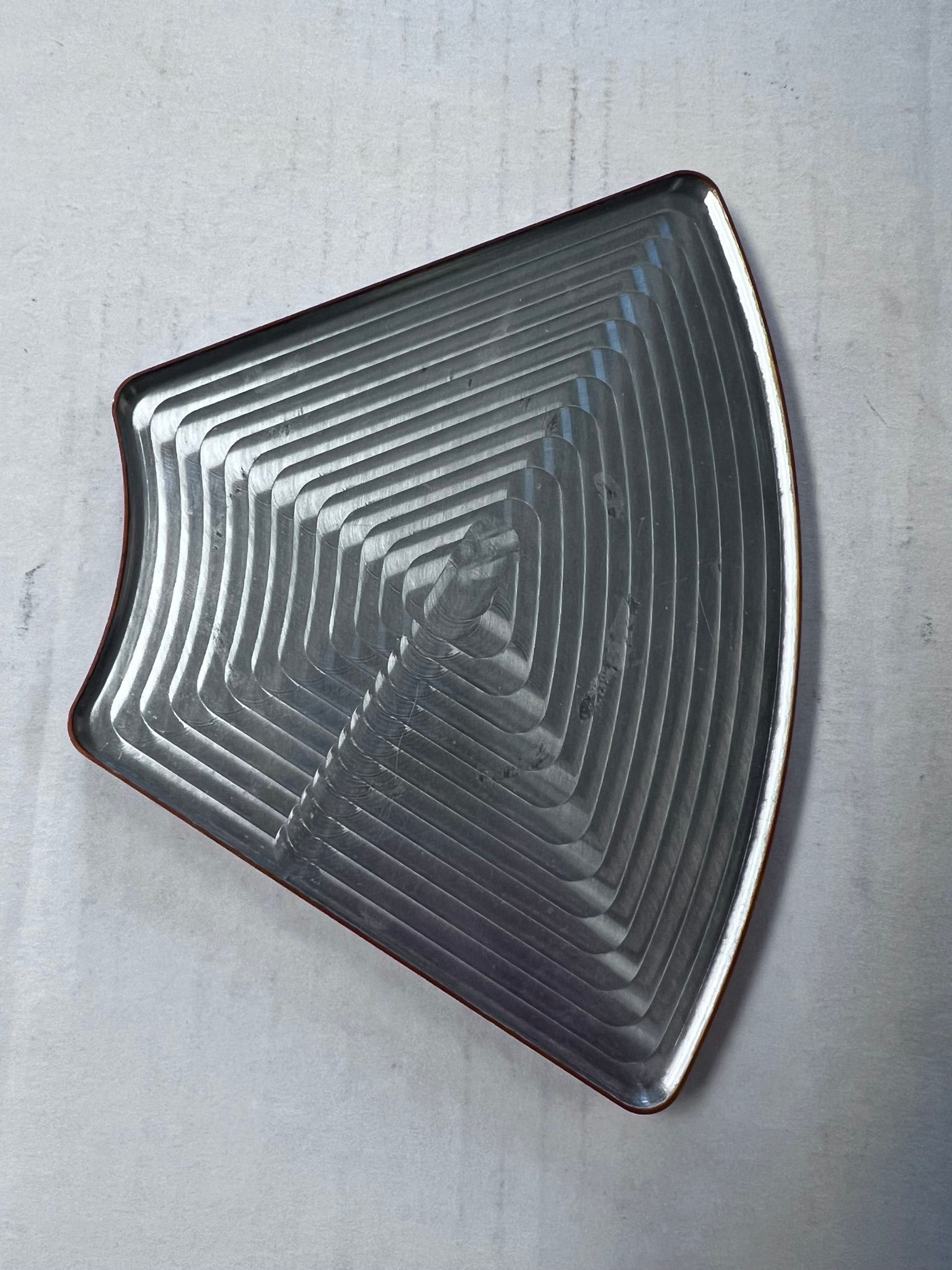 A silver plate with a geometric pattern on it