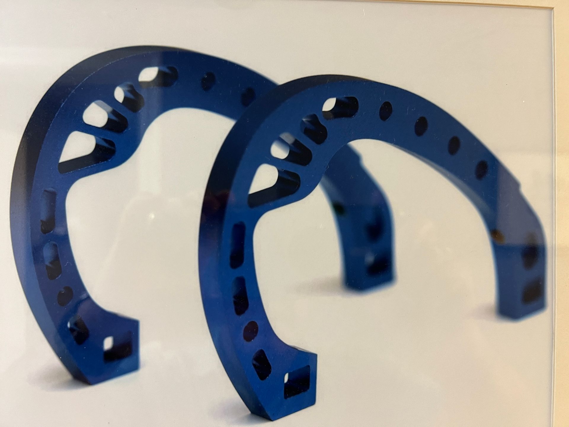 A pair of blue horseshoes on a white background