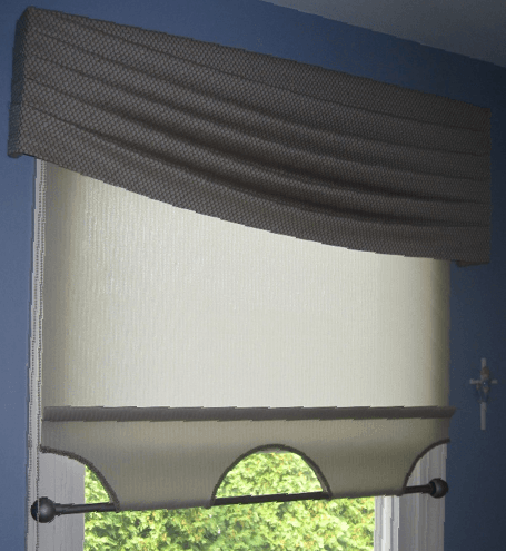 An asymetrical fabric valance hung over a light filtering roller shade with bottom rod hardware. This is an interesting twist for a window!