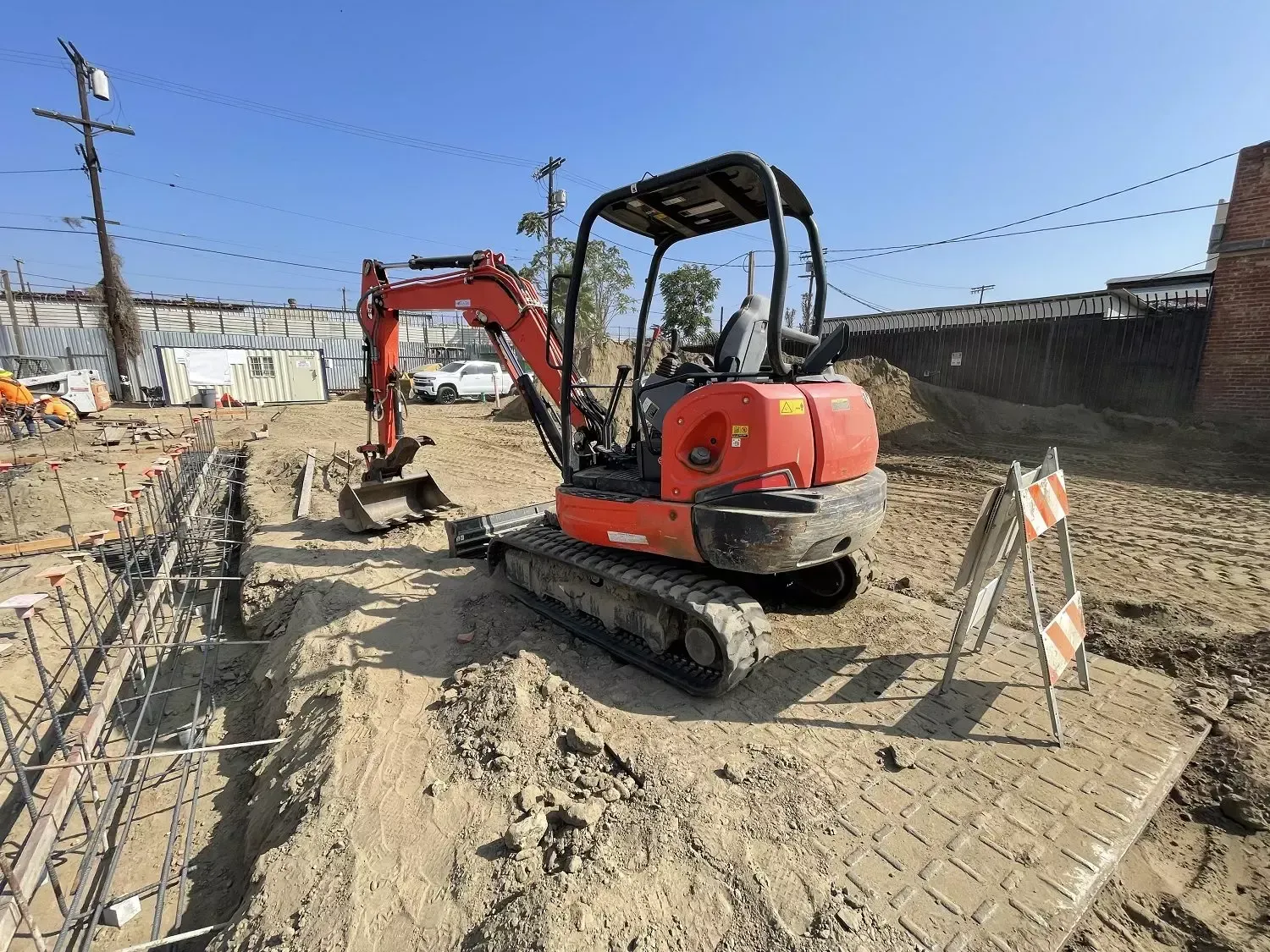 Hydrovac daylighting storm drain connection at commercial site