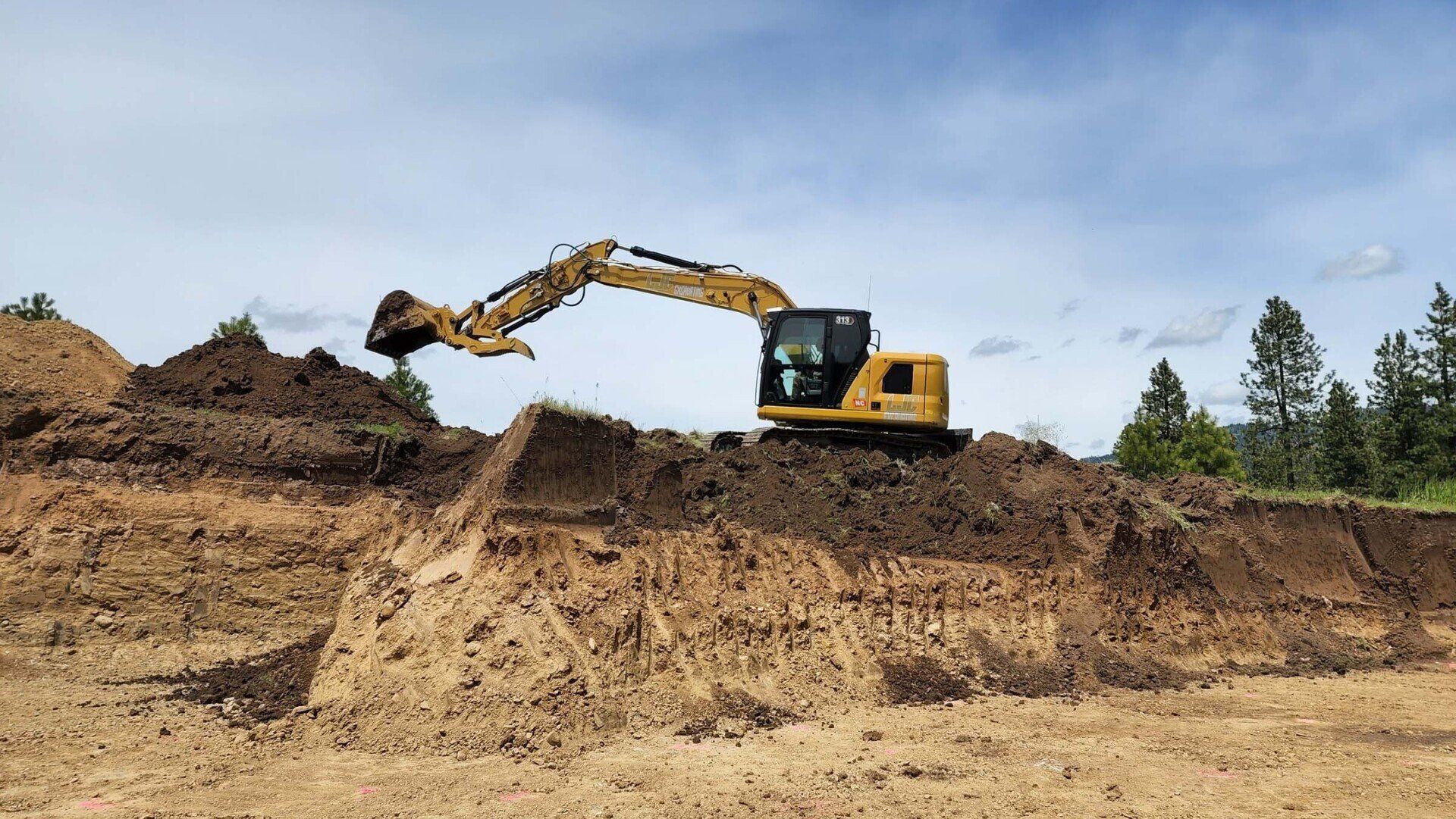 Backhoe rough-grading acreage for new home site