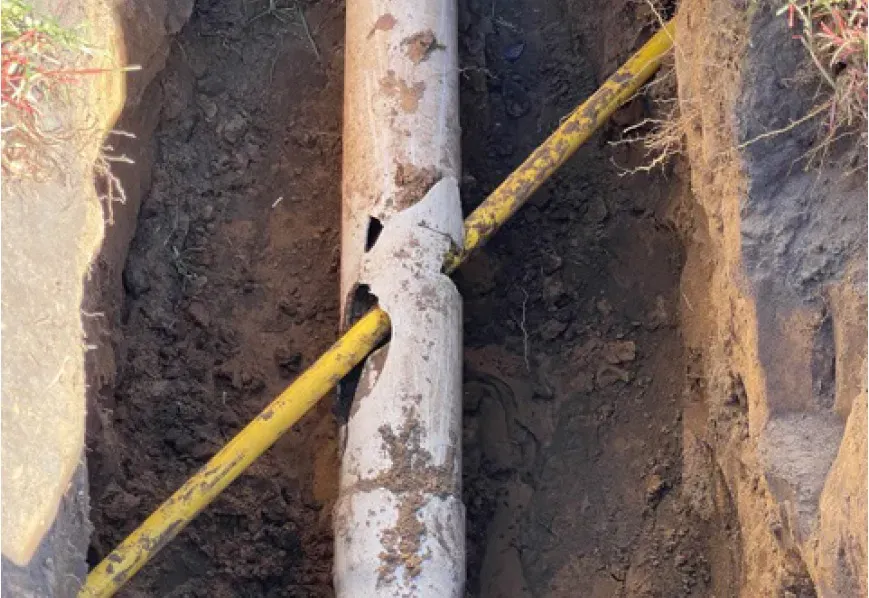 Crew installing shoring for deep trench excavation