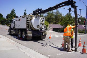 Worker measuring trench depth for new utility installation