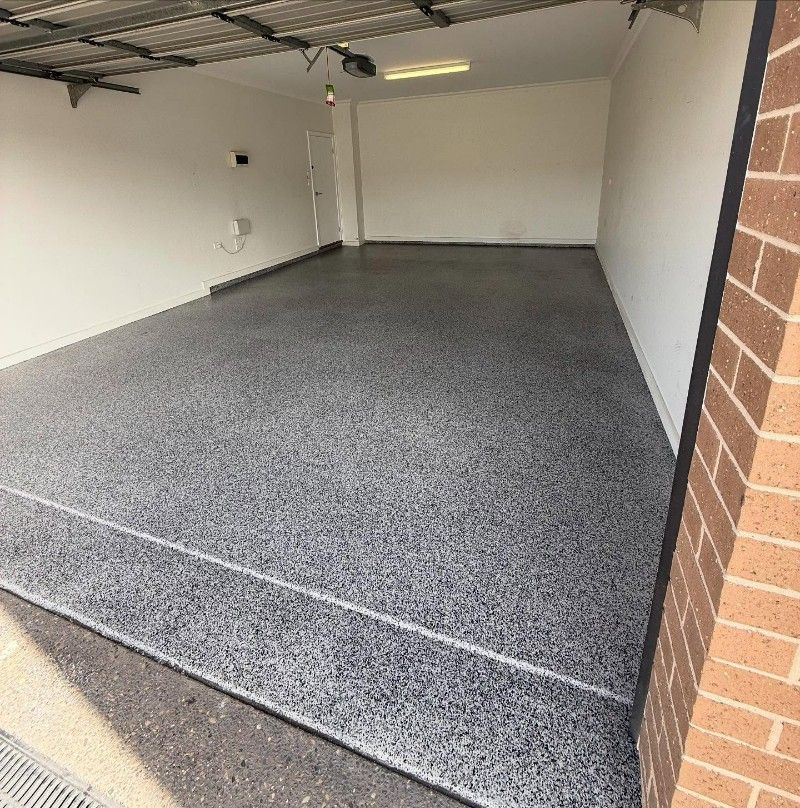 A Garage With a Concrete Floor and a Brick Wall — Premier Epoxy Flooring Wollongong in Wollongong, NSW