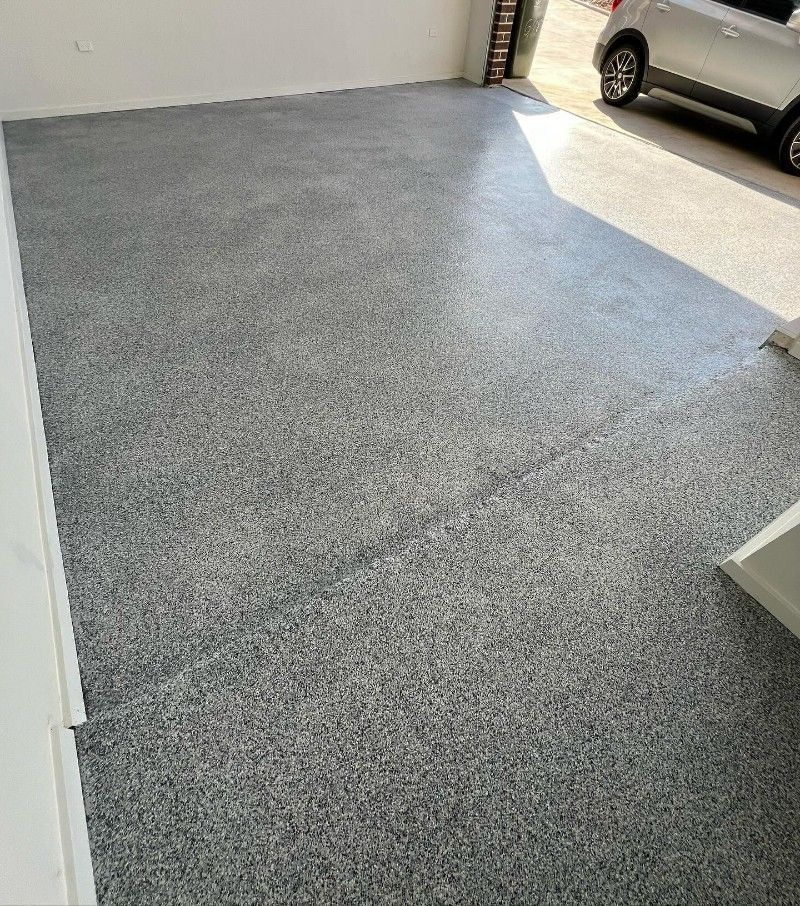 A Car is Parked in a Garage With a Gray Floor — Premier Epoxy Flooring Wollongong in Wollongong, NSW