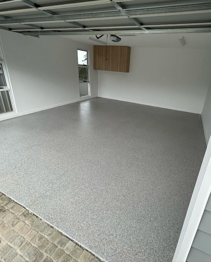 A Garage With a Concrete Floor and White Walls — Premier Epoxy Flooring Wollongong in Wollongong, NSW